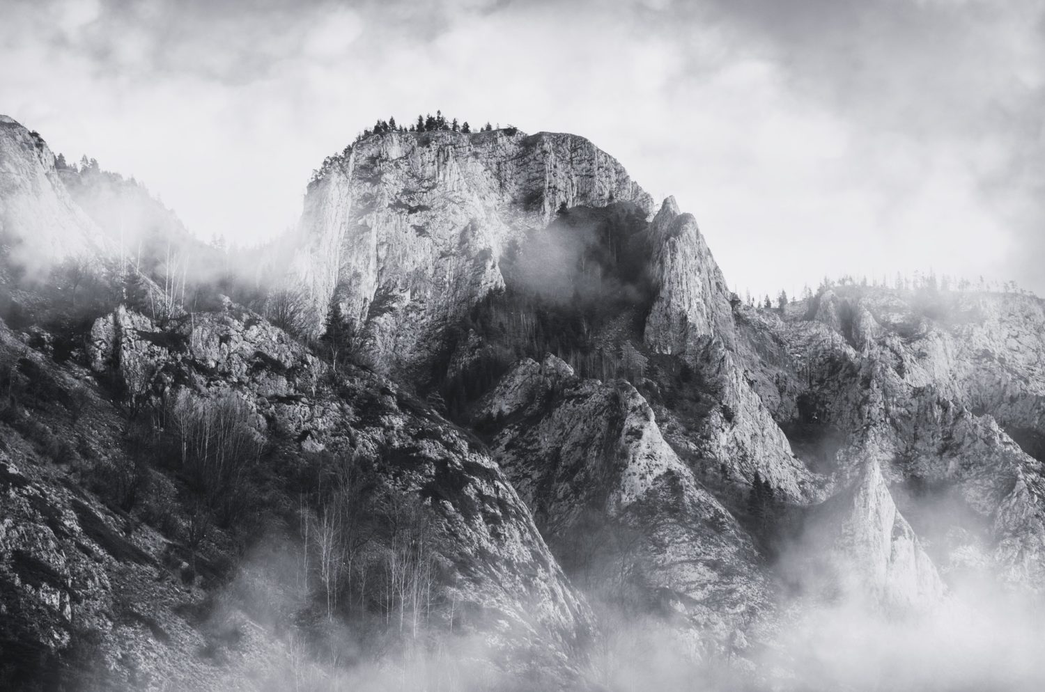 Mountain landscape with fog over cliff